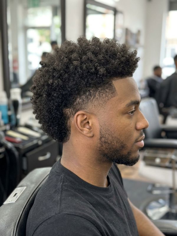 Mid burst fade with a rounded curly top