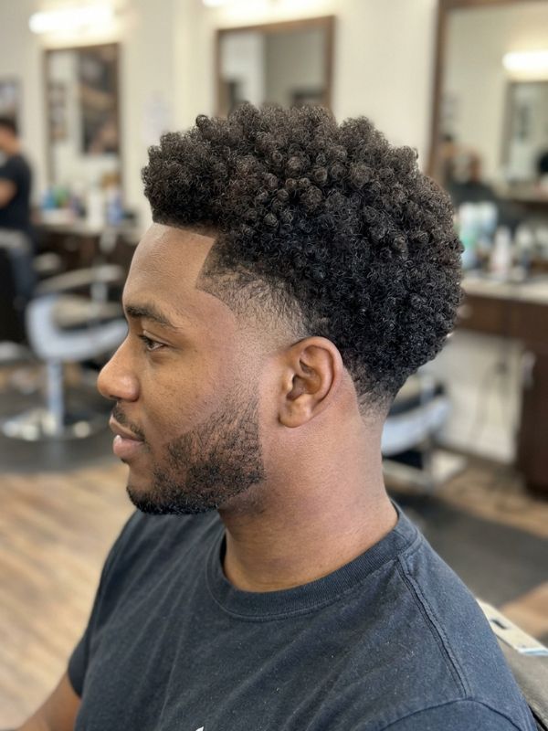 Mid burst fade with a rounded curly top