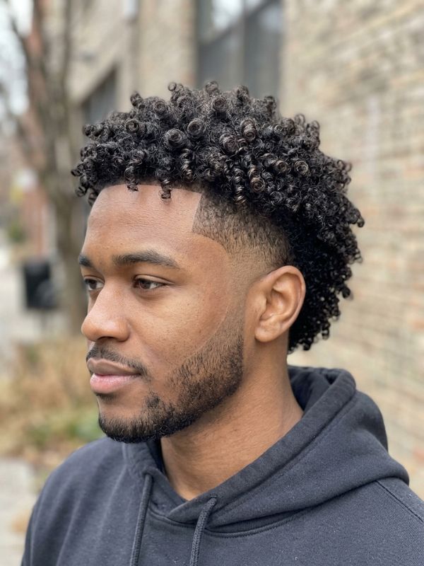 Mid burst fade with defined curls or coils